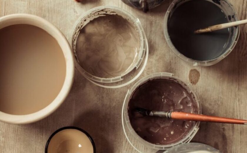close-up-of-paint-brushes-with-pottery-tools-in-bowls-on-table.jpg